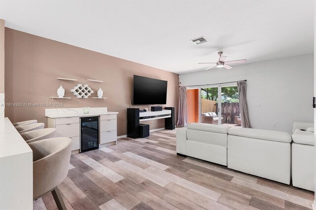 1114 NW 100th Ave, Pembroke Pines, FL 33024 - living area with beverage cooler, light wood-style floors, ceiling fan, and a bar