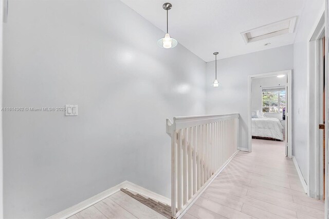 1114 NW 100th Ave, Pembroke Pines, FL 33024 - hallway with an upstairs landing, light wood-style floors, and attic access