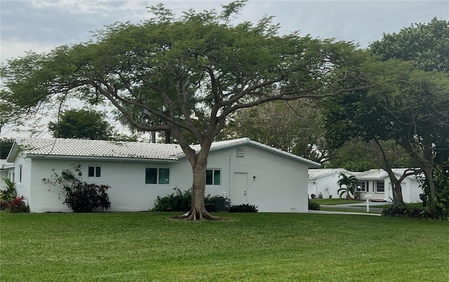1500 NW 90th Way, Plantation, FL 33322 - view of home's exterior with stucco siding, a lawn, and a tile roof