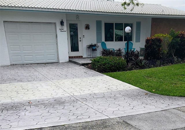 1500 NW 90th Way, Plantation, FL 33322 - entrance to property featuring decorative driveway, a garage, stucco siding, a porch, and a yard