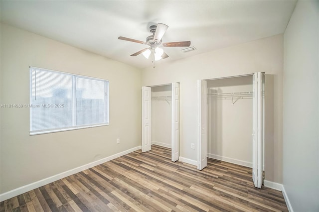 3223 SE 2nd Dr, Homestead, FL 33033 - unfurnished bedroom with two closets, wood finished floors, and ceiling fan