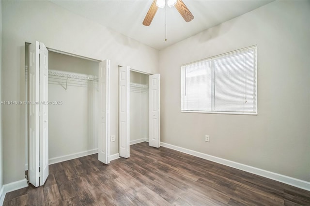 3223 SE 2nd Dr, Homestead, FL 33033 - unfurnished bedroom with two closets, dark wood finished floors, and a ceiling fan