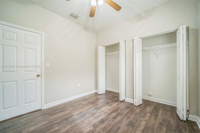 3223 SE 2nd Dr, Homestead, FL 33033 - unfurnished bedroom featuring multiple closets, dark wood-type flooring, and a ceiling fan