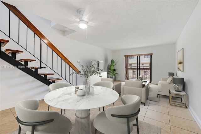 1121 SW 105th Ave Unit 302, Miami, FL 33174 - dining space with baseboards, a ceiling fan, stairway, a textured ceiling, and light tile patterned floors