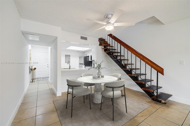 1121 SW 105th Ave Unit 302, Miami, FL 33174 - dining space featuring light tile patterned flooring, a textured ceiling, stairs, baseboards, and a ceiling fan
