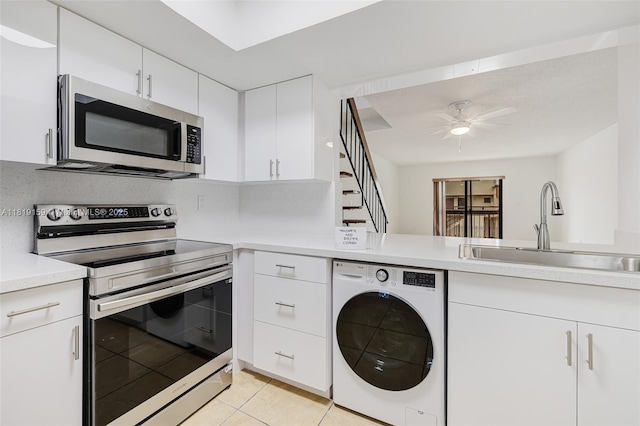 1121 SW 105th Ave Unit 302, Miami, FL 33174 - kitchen featuring washer / clothes dryer, stainless steel appliances, a sink, light countertops, and light tile patterned floors