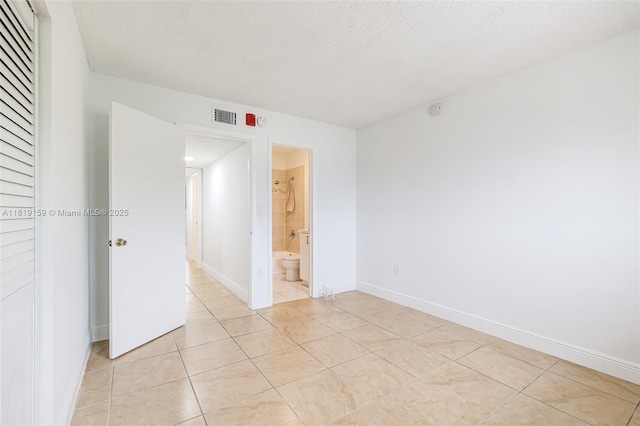1121 SW 105th Ave Unit 302, Miami, FL 33174 - empty room featuring a textured ceiling, light tile patterned flooring, and baseboards