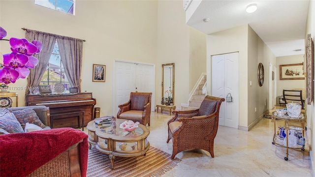 15575 SW 9th Ln, Miami, FL 33194 - living area with a high ceiling, stairway, and baseboards