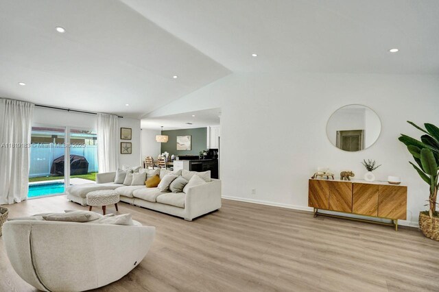 18998 Cloud Lake Cir, Boca Raton, FL 33496 - living area featuring vaulted ceiling, light wood finished floors, and recessed lighting