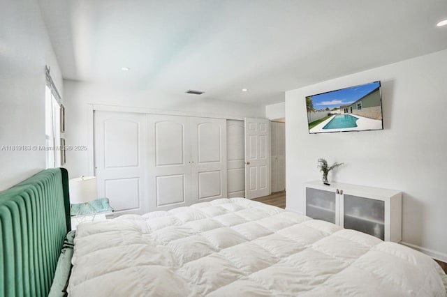 18998 Cloud Lake Cir, Boca Raton, FL 33496 - bedroom featuring a closet, radiator, recessed lighting, and wood finished floors