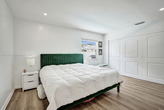 18998 Cloud Lake Cir, Boca Raton, FL 33496 - bedroom with light wood finished floors, a closet, and recessed lighting