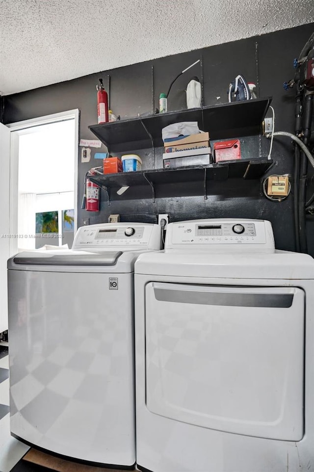 18998 Cloud Lake Cir, Boca Raton, FL 33496 - laundry room featuring washing machine and clothes dryer and a textured ceiling