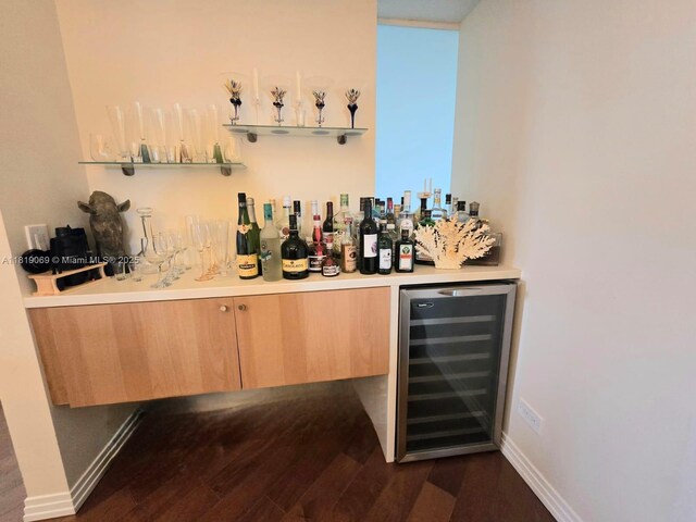 7400 Radice Ct Unit 402, Lauderhill, FL 33319 - indoor dry bar featuring beverage cooler, dark wood-type flooring, and baseboards