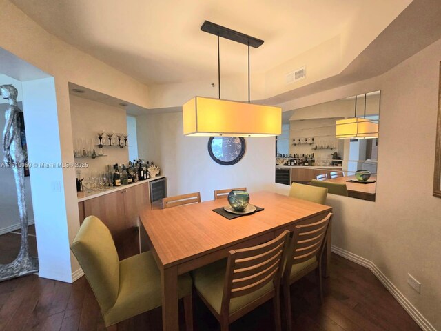 7400 Radice Ct Unit 402, Lauderhill, FL 33319 - dining area with dark wood finished floors, baseboards, and wine cooler
