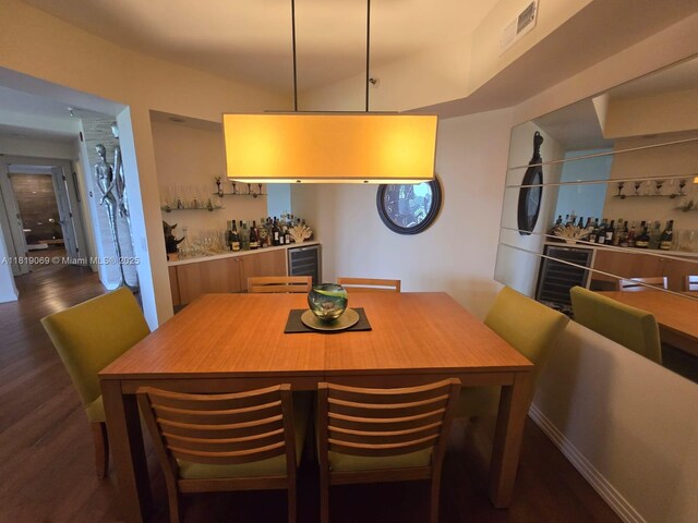 7400 Radice Ct Unit 402, Lauderhill, FL 33319 - dining space with dark wood-style floors, wine cooler, and a bar