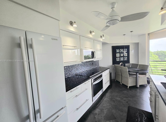 7400 Radice Ct Unit 402, Lauderhill, FL 33319 - kitchen featuring white appliances, white cabinetry, dark countertops, modern cabinets, and ceiling fan