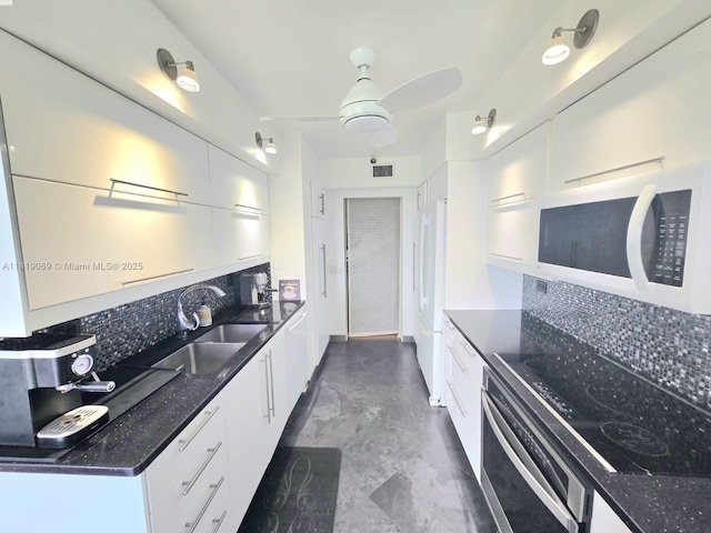 7400 Radice Ct Unit 402, Lauderhill, FL 33319 - kitchen with white appliances, a sink, decorative backsplash, and white cabinets