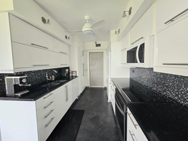7400 Radice Ct Unit 402, Lauderhill, FL 33319 - kitchen featuring a sink, white appliances, white cabinets, and tasteful backsplash