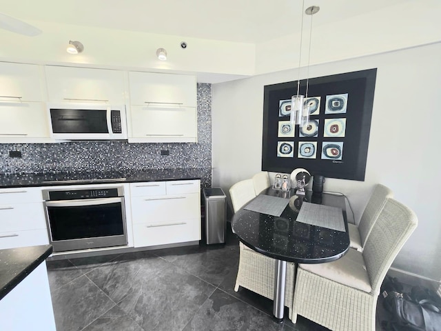 7400 Radice Ct Unit 402, Lauderhill, FL 33319 - kitchen with oven, white microwave, modern cabinets, and white cabinets