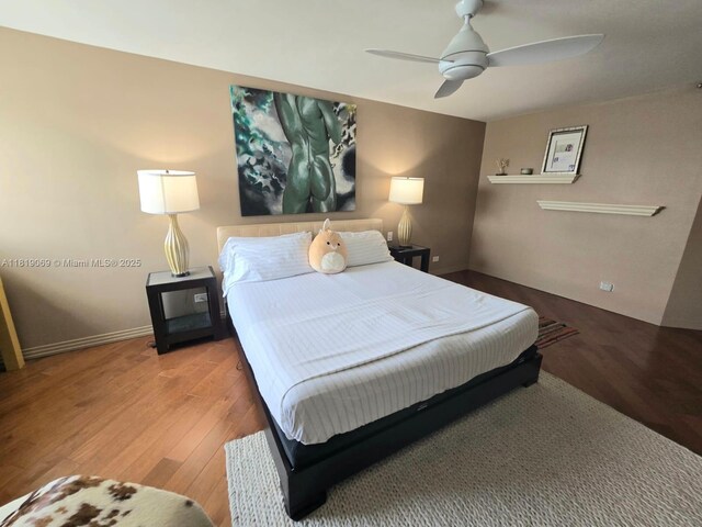 7400 Radice Ct Unit 402, Lauderhill, FL 33319 - bedroom with wood finished floors, ceiling fan, and baseboards