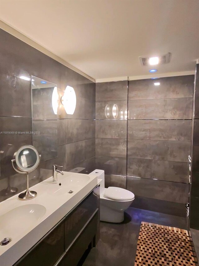 7400 Radice Ct Unit 402, Lauderhill, FL 33319 - bathroom featuring tile walls, double vanity, and toilet