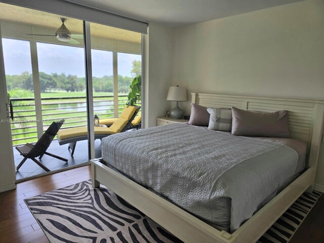 7400 Radice Ct Unit 402, Lauderhill, FL 33319 - bedroom featuring multiple windows, a water view, hardwood / wood-style flooring, and access to outside