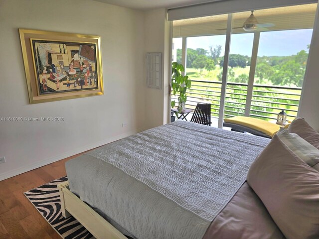 7400 Radice Ct Unit 402, Lauderhill, FL 33319 - bedroom featuring baseboards, access to exterior, and wood finished floors