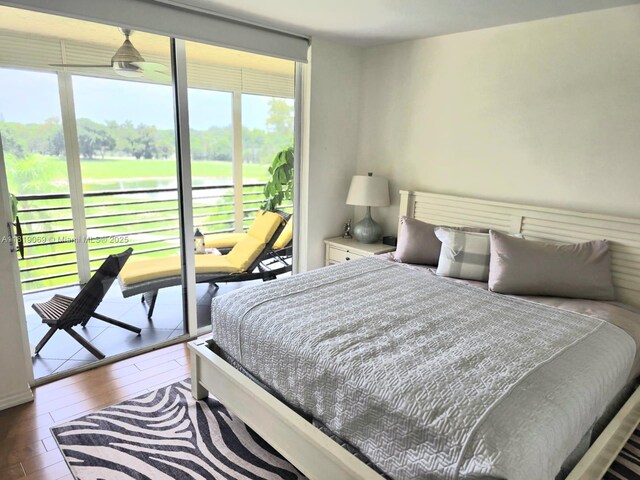 7400 Radice Ct Unit 402, Lauderhill, FL 33319 - bedroom featuring multiple windows, wood finished floors, view of golf course, and access to exterior