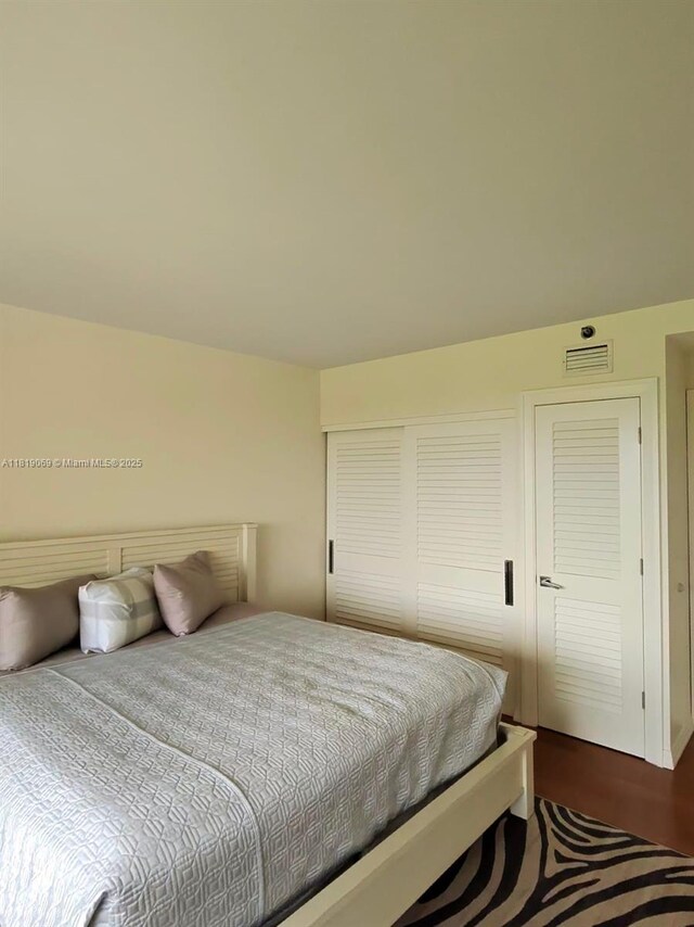 7400 Radice Ct Unit 402, Lauderhill, FL 33319 - bedroom featuring dark wood-type flooring and a closet