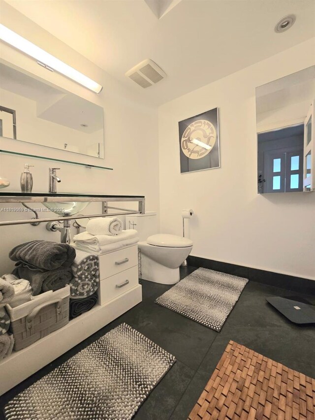 7400 Radice Ct Unit 402, Lauderhill, FL 33319 - bathroom with toilet, vanity, and baseboards