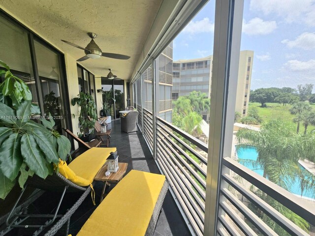 7400 Radice Ct Unit 402, Lauderhill, FL 33319 - balcony featuring a ceiling fan and view of pool area
