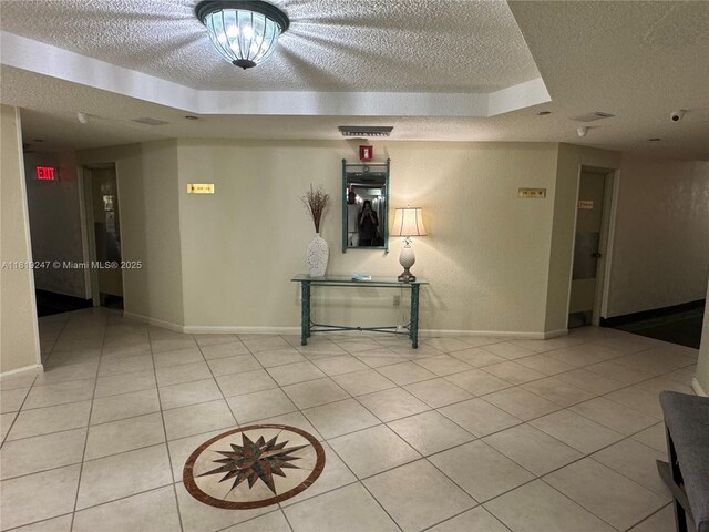 1100 Saint Charles Pl Unit 203, Pembroke Pines, FL 33026 - hall with a textured ceiling, light tile patterned floors, and baseboards