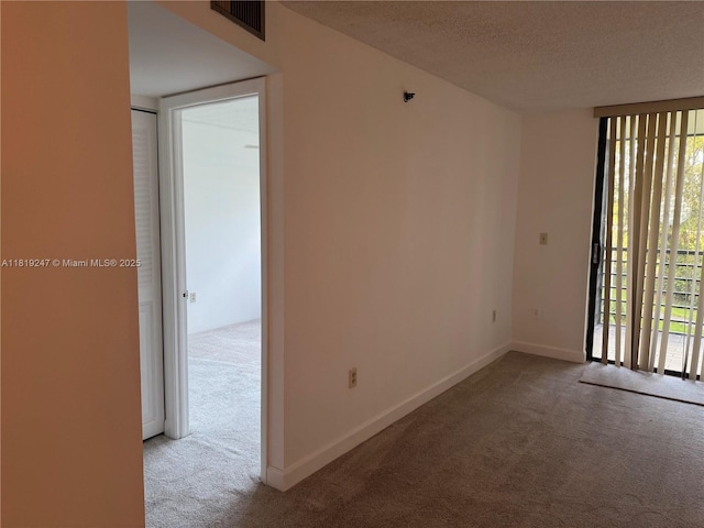 1100 Saint Charles Pl Unit 203, Pembroke Pines, FL 33026 - unfurnished room featuring carpet flooring, a textured ceiling, and baseboards