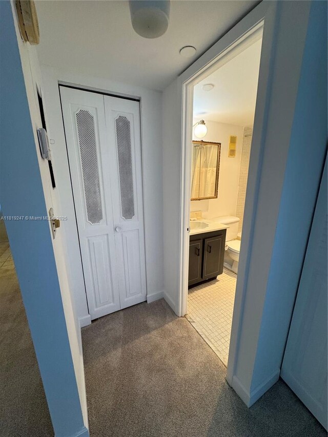 1100 Saint Charles Pl Unit 203, Pembroke Pines, FL 33026 - hallway with light colored carpet, a sink, and baseboards