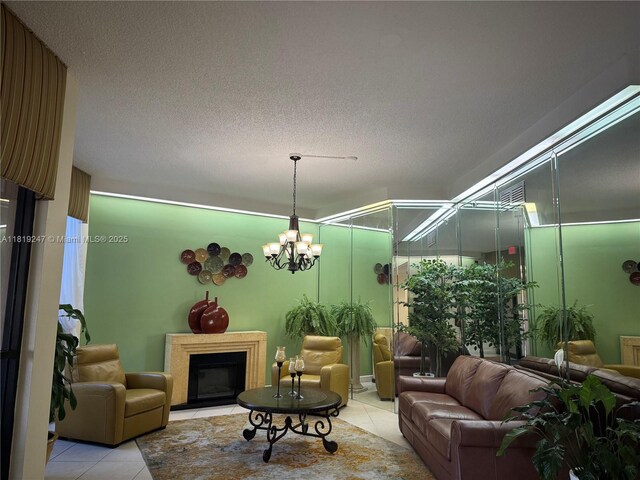 1100 Saint Charles Pl Unit 203, Pembroke Pines, FL 33026 - living area with light tile patterned flooring, a fireplace, a textured ceiling, and a chandelier