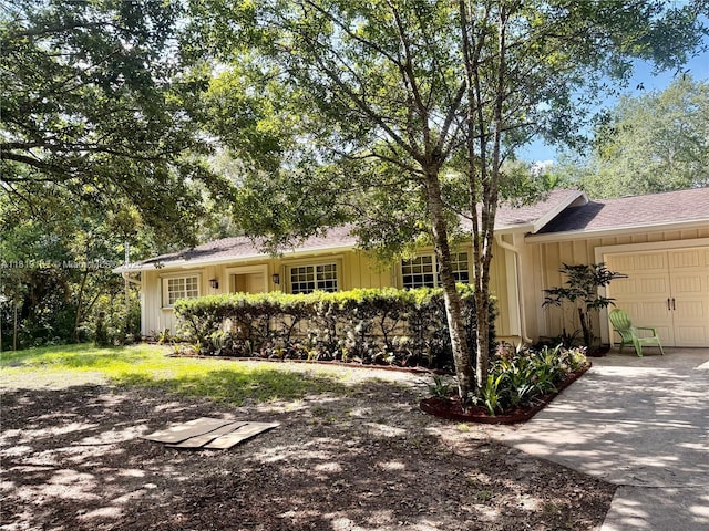 14360 SW 20th St, Davie, FL 33325 - ranch-style home featuring an attached garage, board and batten siding, driveway, and a shingled roof