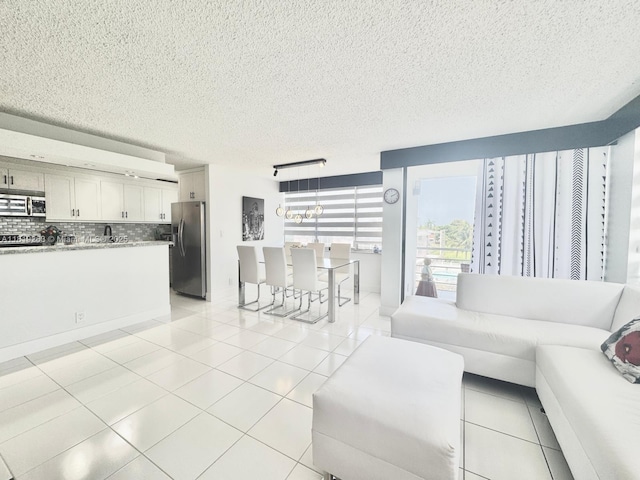 2741 Taft St Unit 410, Hollywood, FL 33020 - living area featuring a textured ceiling and light tile patterned floors