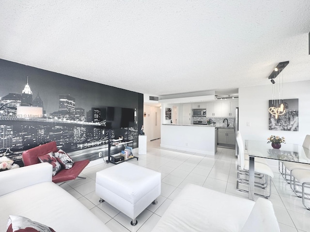 2741 Taft St Unit 410, Hollywood, FL 33020 - living room with a textured ceiling, light tile patterned floors, and a chandelier