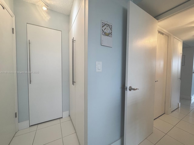 2741 Taft St Unit 410, Hollywood, FL 33020 - hallway with light tile patterned floors and a textured ceiling