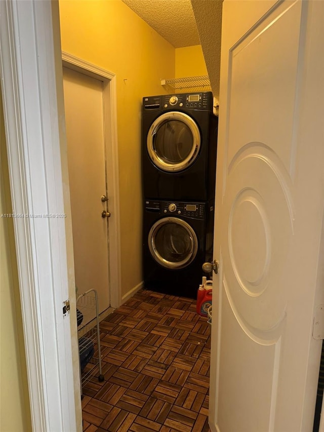 15048 SW 51st St, Davie, FL 33331 - laundry area featuring stacked washer / drying machine and a textured ceiling