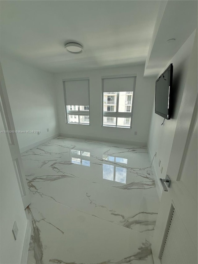 7350 SW 89th St Unit 2011S, Miami, FL 33156 - spare room featuring marble look tile flooring and baseboards