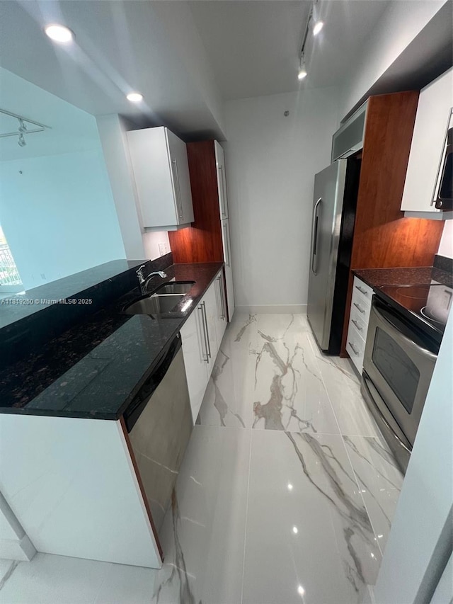 7350 SW 89th St Unit 2011S, Miami, FL 33156 - kitchen featuring appliances with stainless steel finishes, a sink, light marble finish flooring, white cabinetry, and dark stone counters