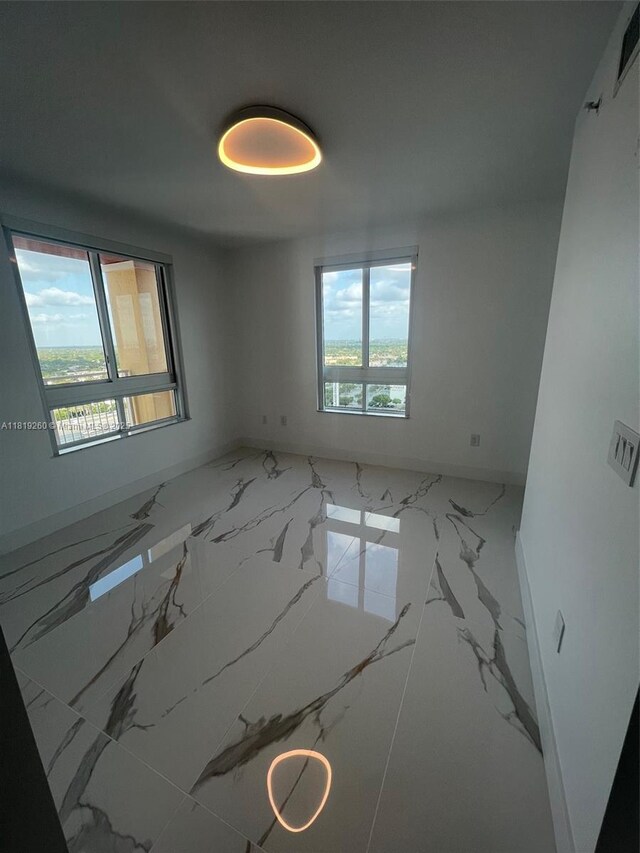 7350 SW 89th St Unit 2011S, Miami, FL 33156 - spare room with marble tiled floors and baseboards