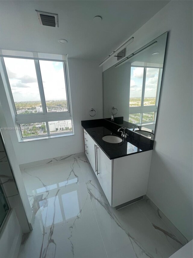 7350 SW 89th St Unit 2011S, Miami, FL 33156 - bathroom with vanity, marble finish flooring, healthy amount of natural light, and baseboards