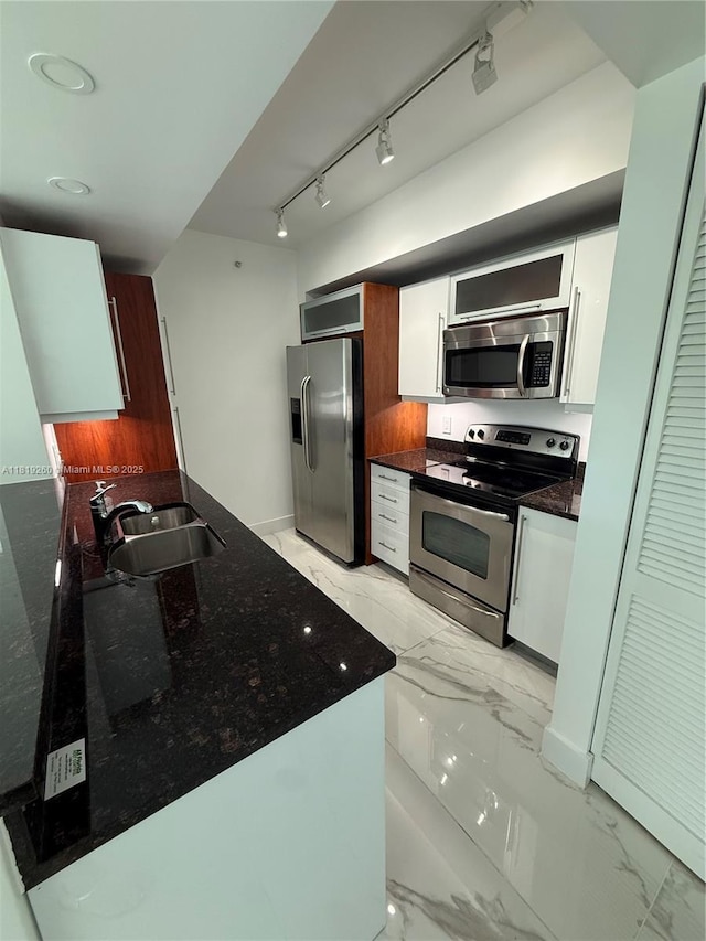 7350 SW 89th St Unit 2011S, Miami, FL 33156 - kitchen with stainless steel appliances, light marble finish floors, white cabinets, and dark stone counters