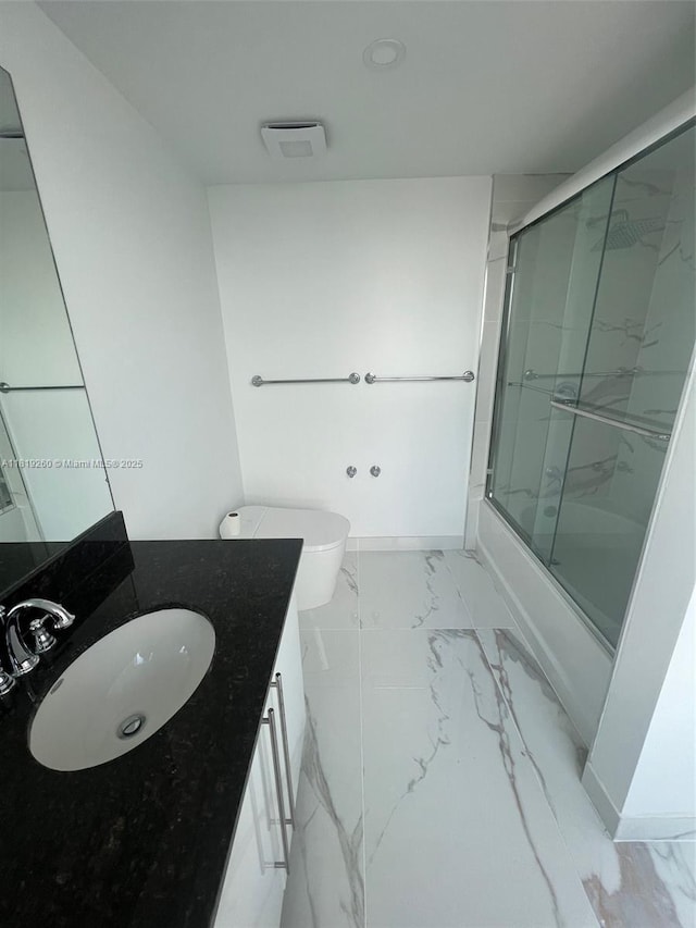 7350 SW 89th St Unit 2011S, Miami, FL 33156 - bathroom featuring marble look tiles, vanity, shower / bath combination with glass door, and toilet