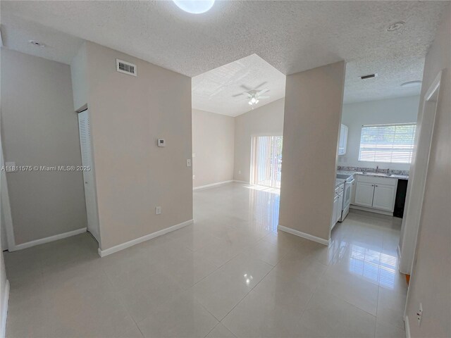 1881 NW 96th Ter Unit 7C, Pembroke Pines, FL 33024 - hall featuring plenty of natural light, a textured ceiling, light tile patterned floors, and lofted ceiling