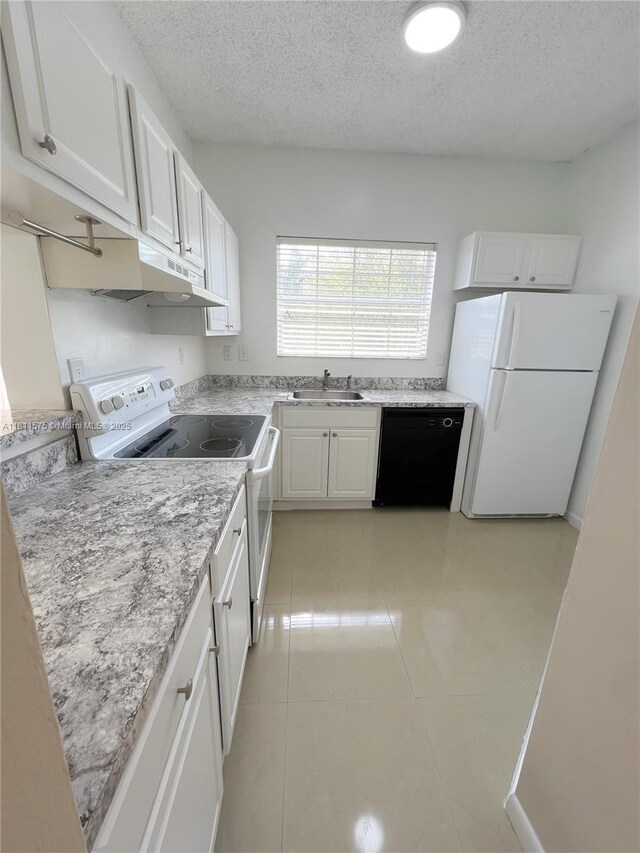 1881 NW 96th Ter Unit 7C, Pembroke Pines, FL 33024 - kitchen featuring white appliances, white cabinets, a textured ceiling, light tile patterned flooring, and light stone countertops