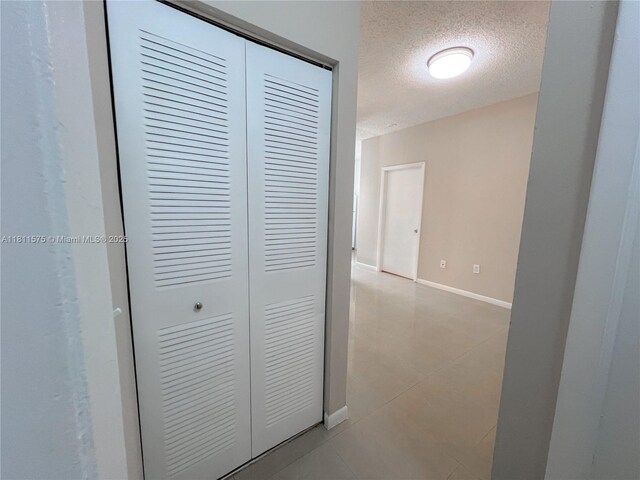 1881 NW 96th Ter Unit 7C, Pembroke Pines, FL 33024 - hall with a textured ceiling and light tile patterned floors