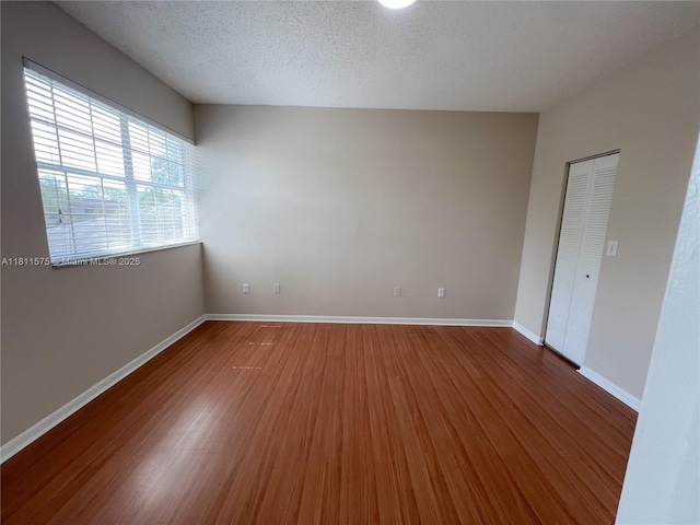 1881 NW 96th Ter Unit 7C, Pembroke Pines, FL 33024 - spare room featuring wood finished floors and baseboards